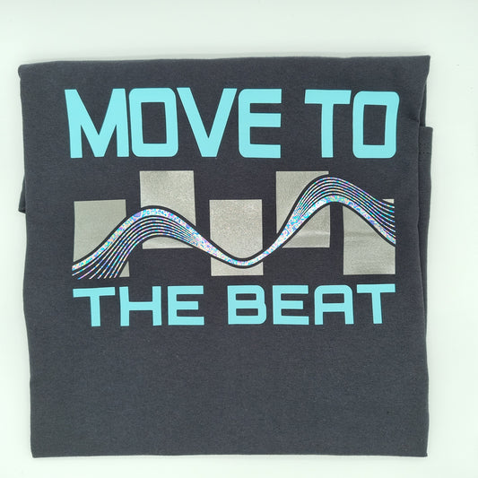 Folded t-shirt with "MOVE TO THE BEAT" printed onto it in a light-blue modern font, accompanied by a metallic wave graphic