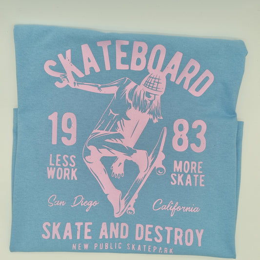 Blue t-shirt with a pink graphic of a girl skating