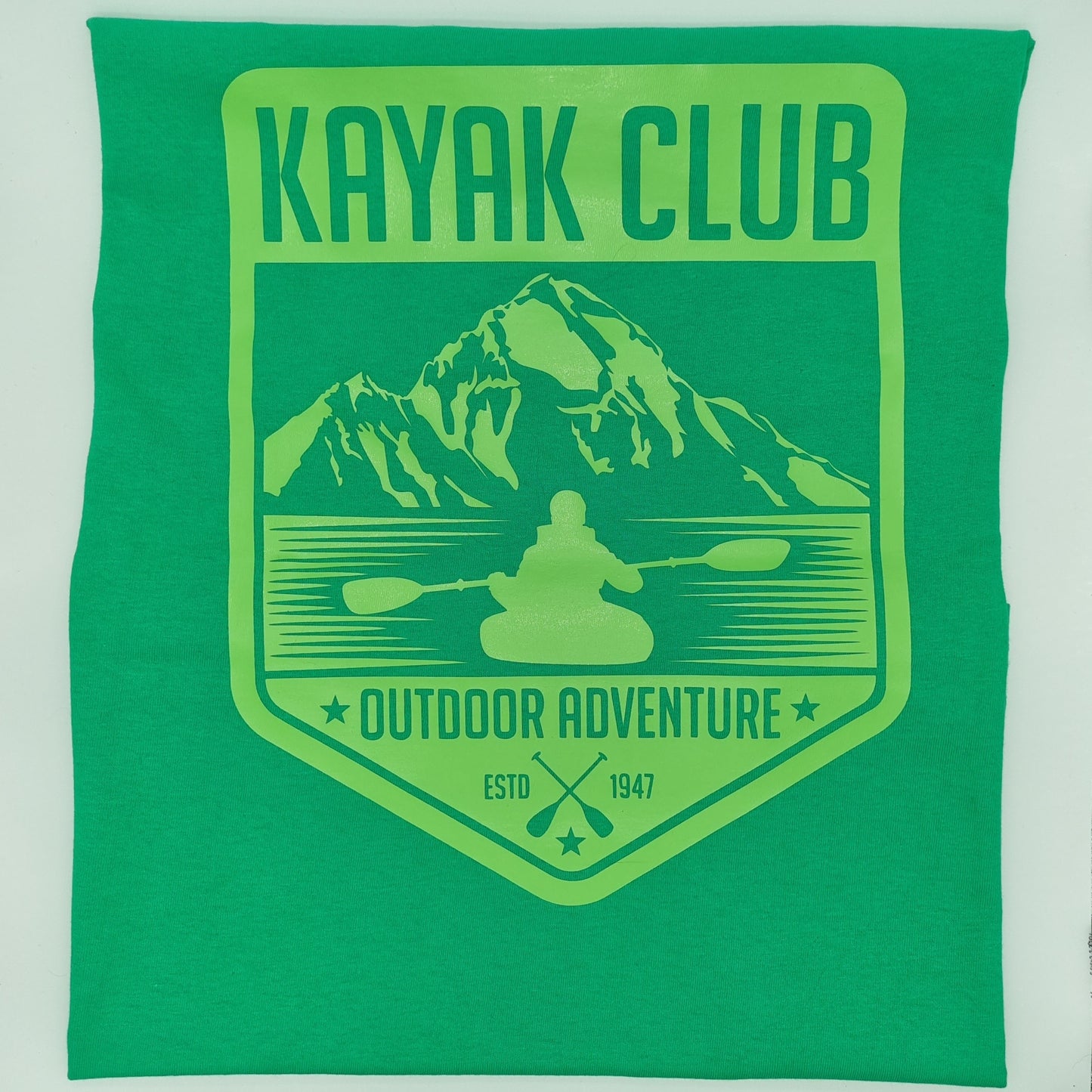 Green t-shirt with a lime green graphic with a person kayaking in front of a mountain, Kayak Club Outdoor Adventure