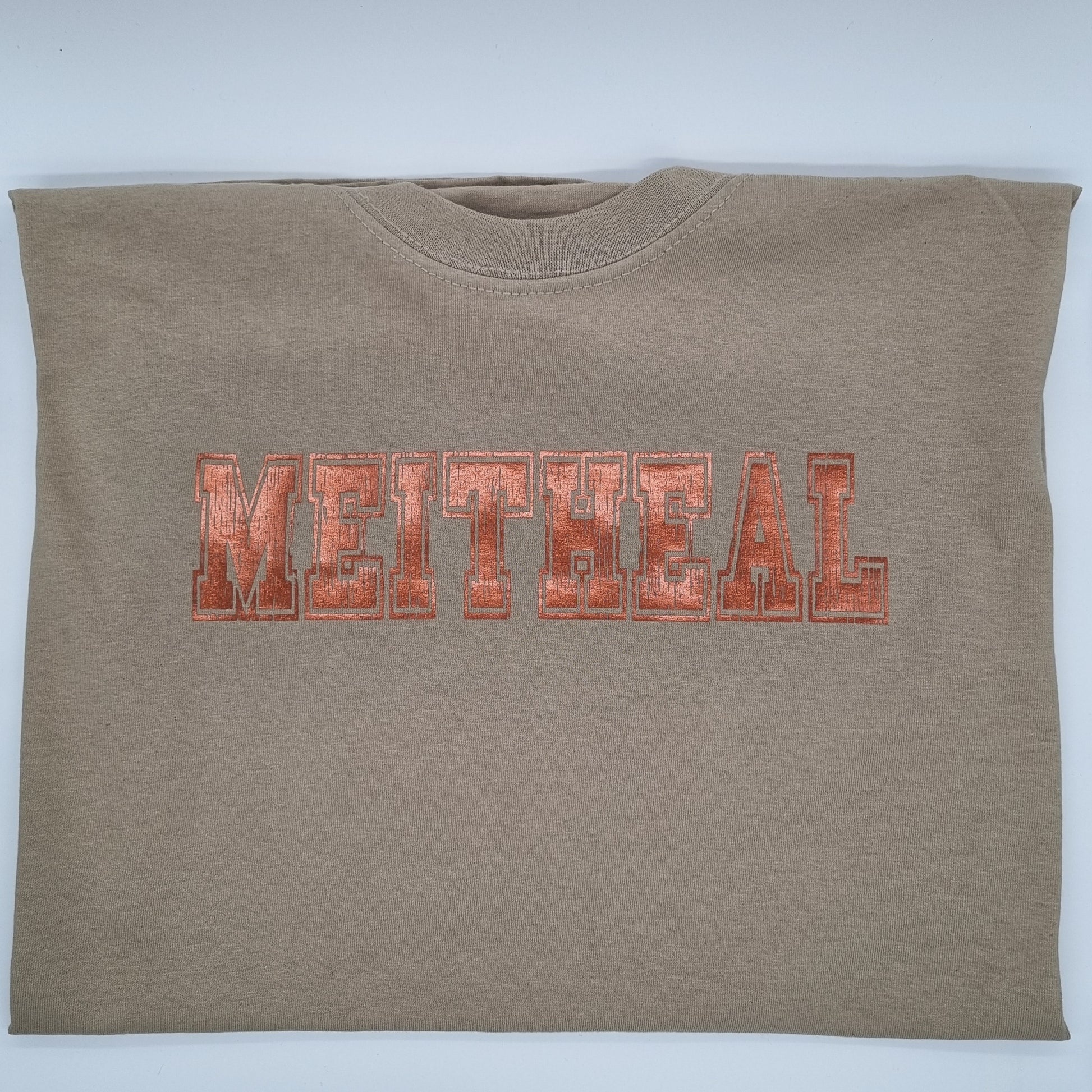 Olive green t-shirt with "Meitheal" printed on it in a copper varsity font