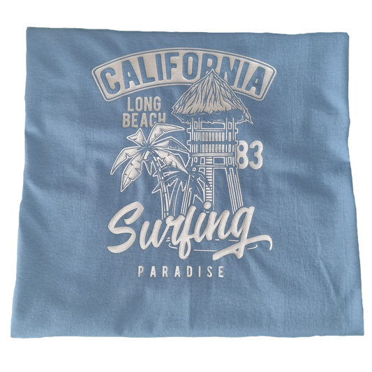 Light blue t-shirt with a white graphic of a palm tree and hut, California Long Beach '83 Surfing Paradise